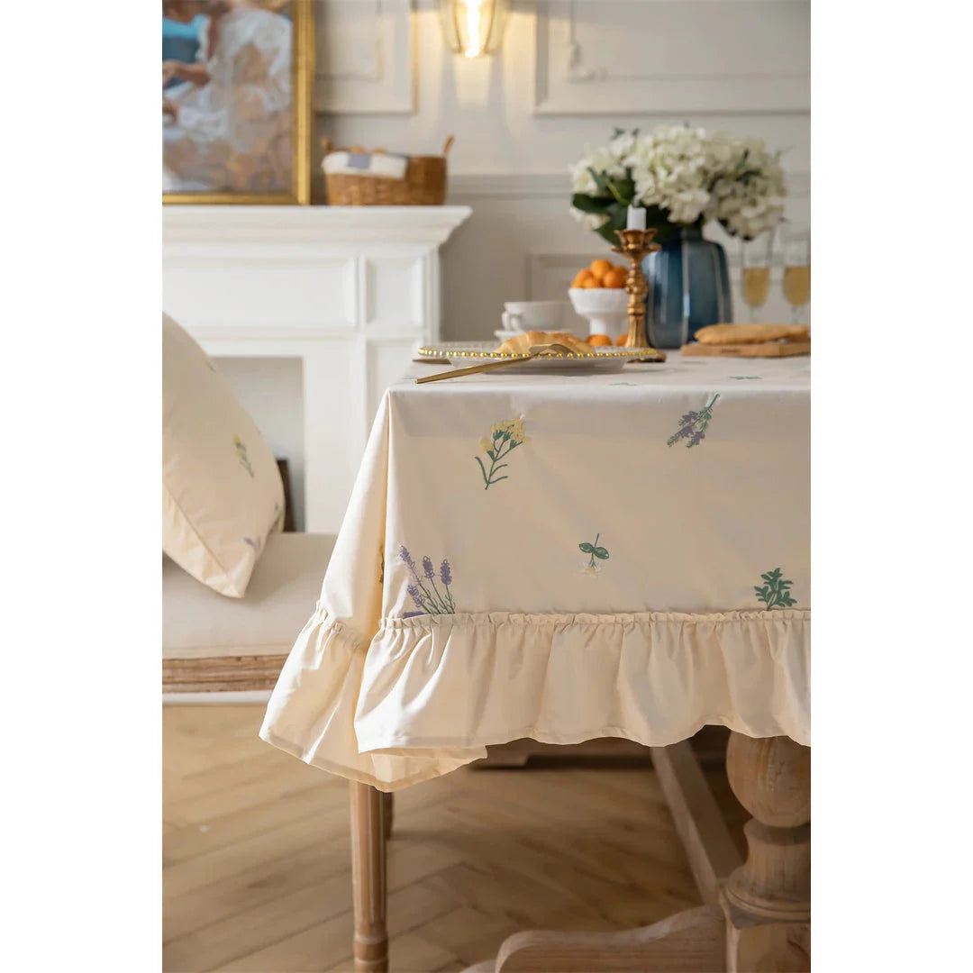 Elegant cotton apricot embroidered tablecloth with a folded lotus leaf edge, adding sophistication to any dining setting.