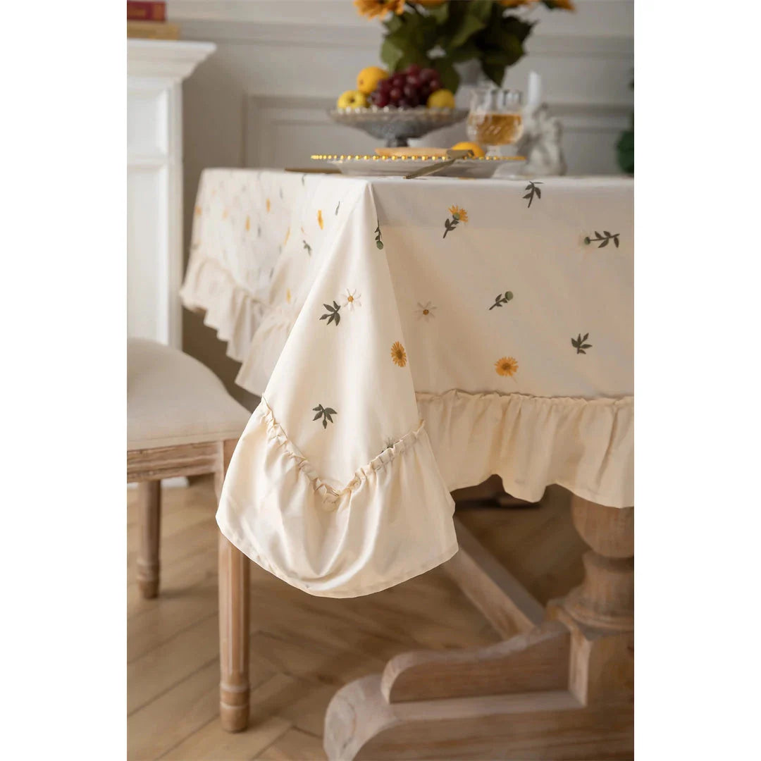 Elegant cotton apricot embroidered tablecloth with a folded lotus leaf edge, adding sophistication to any dining setting.