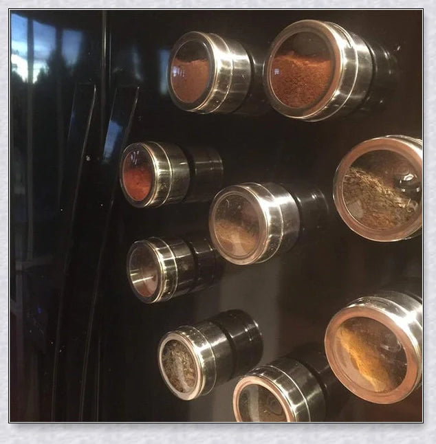 Magnetic spice jars with stainless steel canisters, BPA-free lids, and a magnetic rack for easy storage and organization in the kitchen.