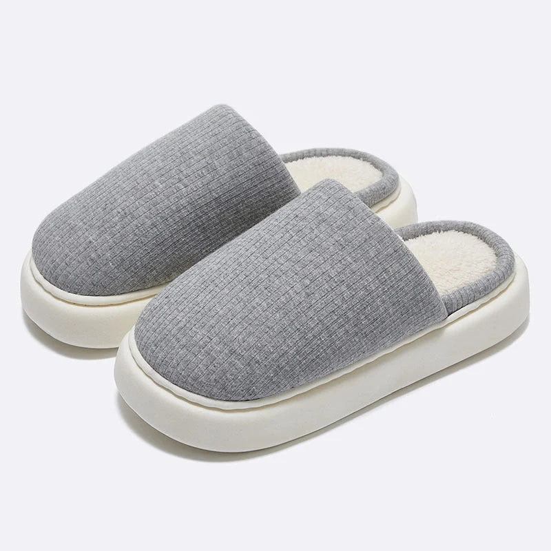 Cosy knitted fabric slippers in various colours and sizes, designed for couples to enjoy comfortable indoor relaxation.