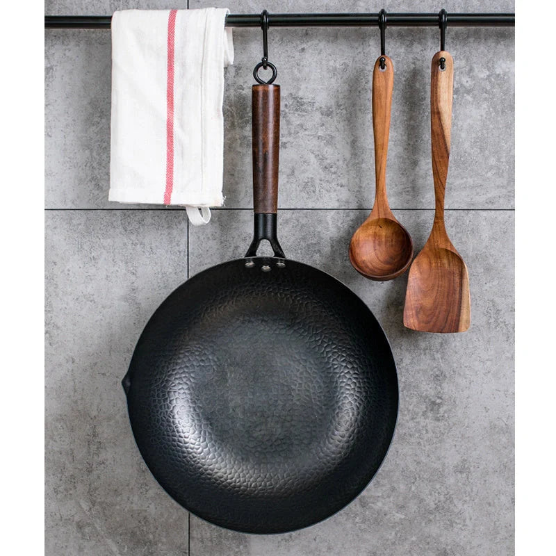 Traditional handmade iron wok with wooden handle and lid