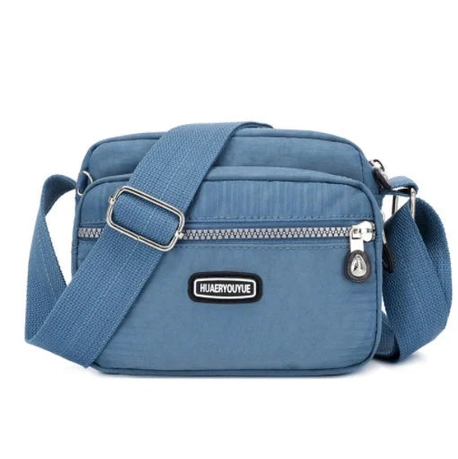 Small square messenger bag in water-repellent nylon with multi-compartment design