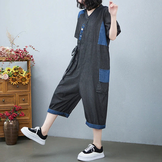 Women's denim drawstring jumpsuit with wide legs and cropped length, available in blue and black colours