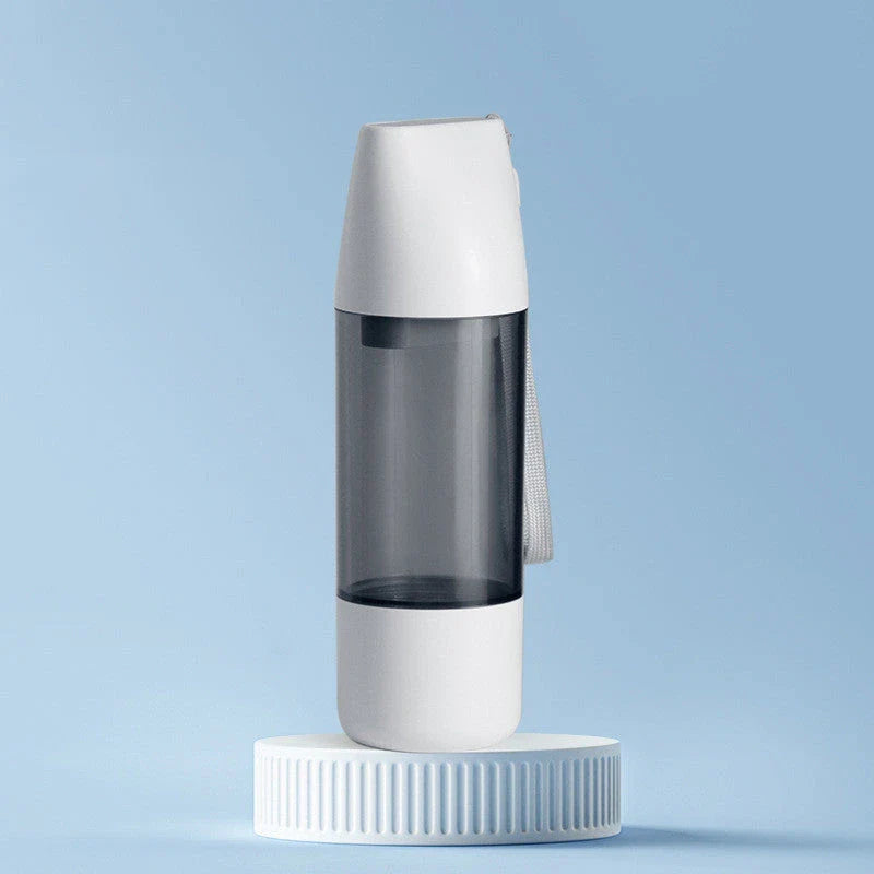 Portable pet water bottle with food container compartment, made of durable ABS plastic and silicone for outdoor use