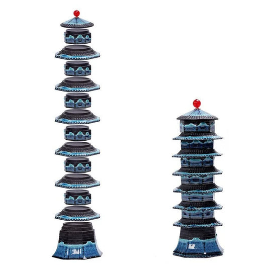 A beautiful porcelain tea set with a pagoda design, including a teapot, cups, trays, and a carrying bag for easy portability.