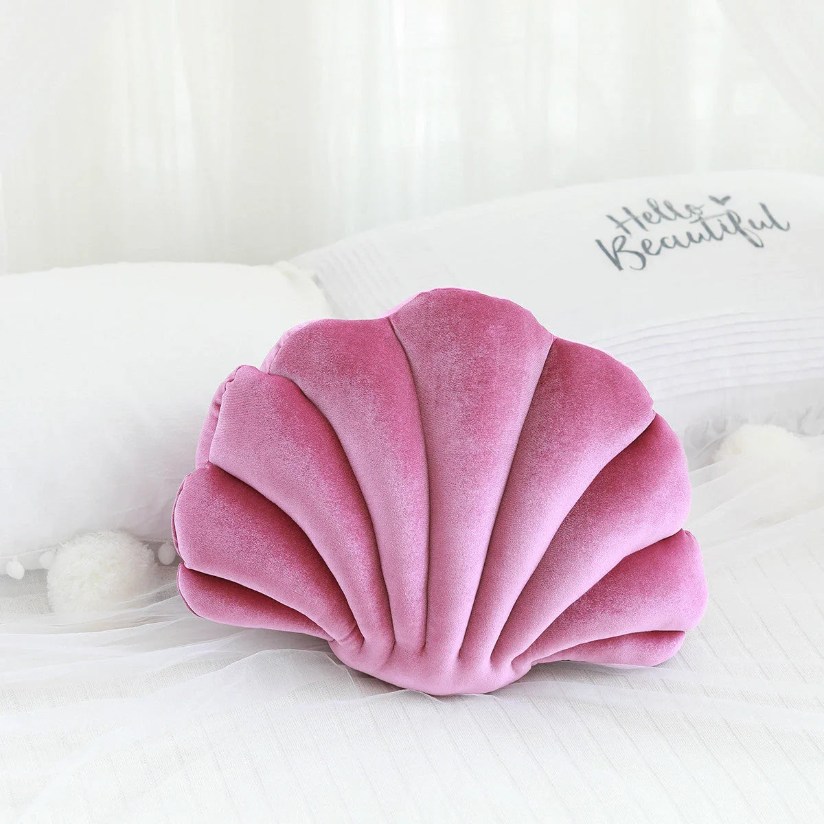 Cosy shell-shaped plush nap pillow in various colours and sizes for ultimate comfort