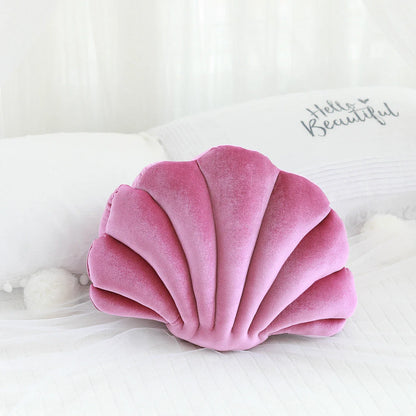 Cosy shell-shaped plush nap pillow in various colours and sizes for ultimate comfort