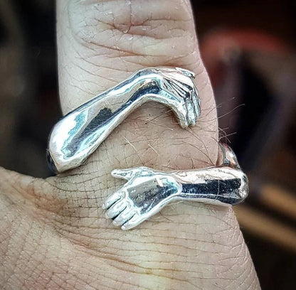 Elegant Adjustable Love Hands Embracing Ring in gold and silver, a perfect symbol of affection