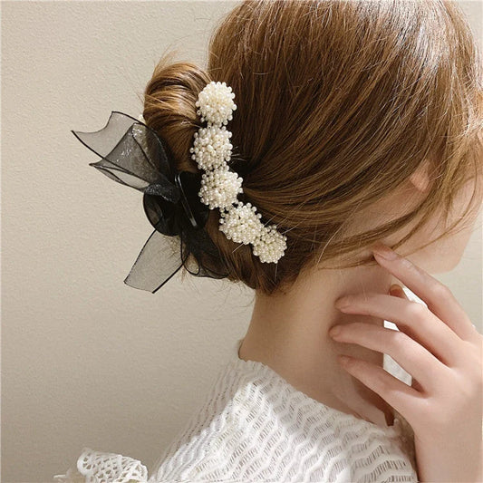 Korean pearl bow hair clip in black, alloy construction for durability and style.