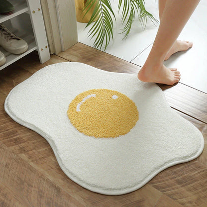 Quirky egg-shaped entrance mat made of absorbent polyester fabric with non-slip rubber backing, available in various sizes and colours