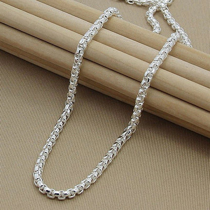 Silver-plated round pendant necklace with secure clasp, showcasing elegant British-inspired design