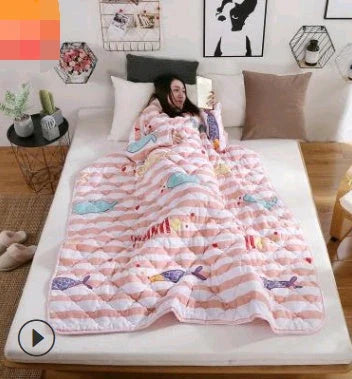 Cozy quilted lounger with sleeves in various colors and sizes, perfect for year-round indoor comfort and relaxation.