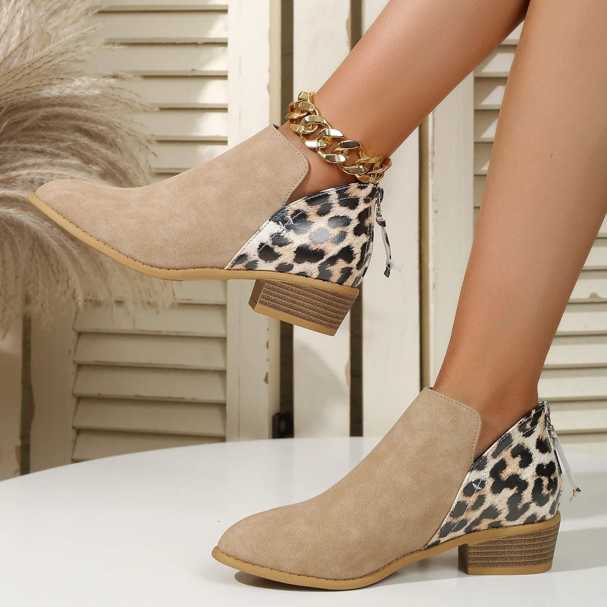Women's leopard print boots with pointed toe and chunky heel, available in multiple sizes