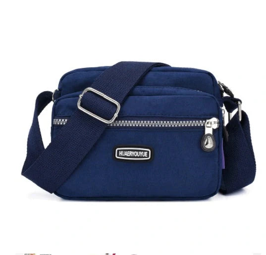 Small square messenger bag in water-repellent nylon with multi-compartment design