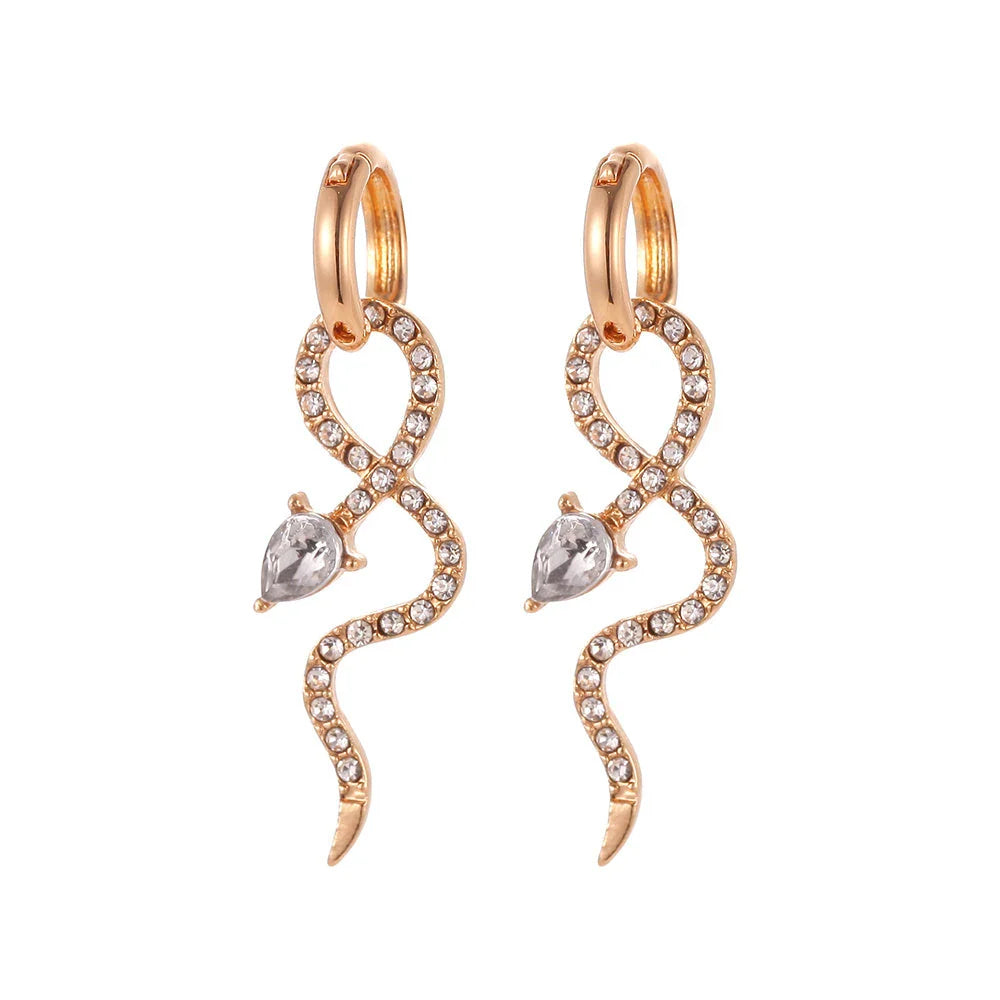 Elegant gold-toned snake charm earrings with a dangle design, perfect for adding a touch of sophistication to any outfit.