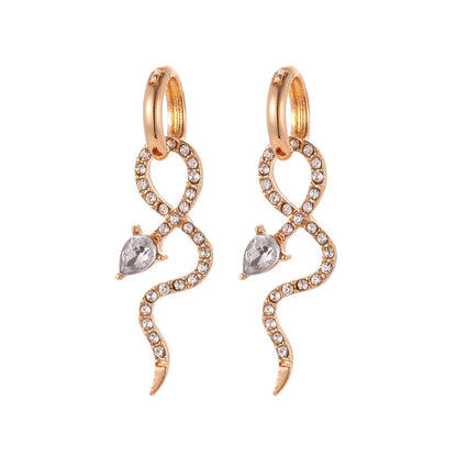 Elegant gold-toned snake charm earrings with a dangle design, perfect for adding a touch of sophistication to any outfit.