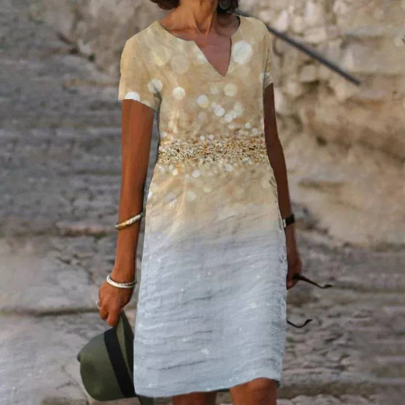 A floral printed midi dress made from a cotton-linen blend fabric, featuring a V-neck and short sleeves.