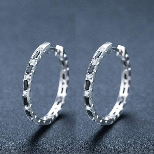 A pair of elegant black zircon earrings with a round, geometric design made of premium copper