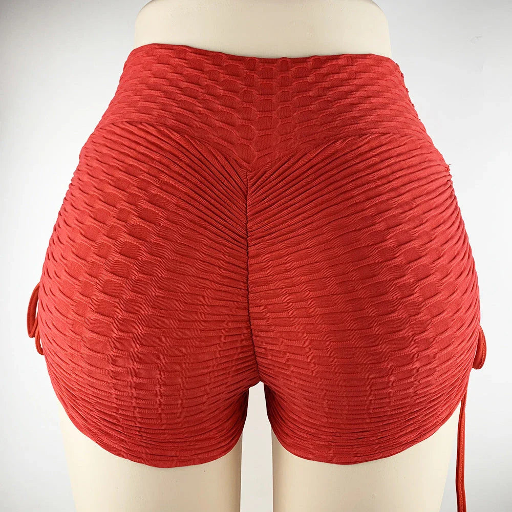 Stylish butt-lifting workout shorts with drawstring, available in various colors including pink, red, grey, navy, and black