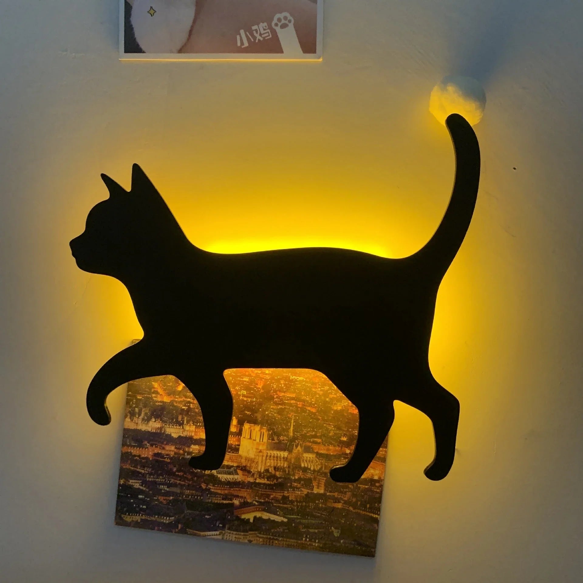 A stylish cat-shaped smart sensor night light that automatically illuminates a room when motion is detected, creating a warm and cozy atmosphere.