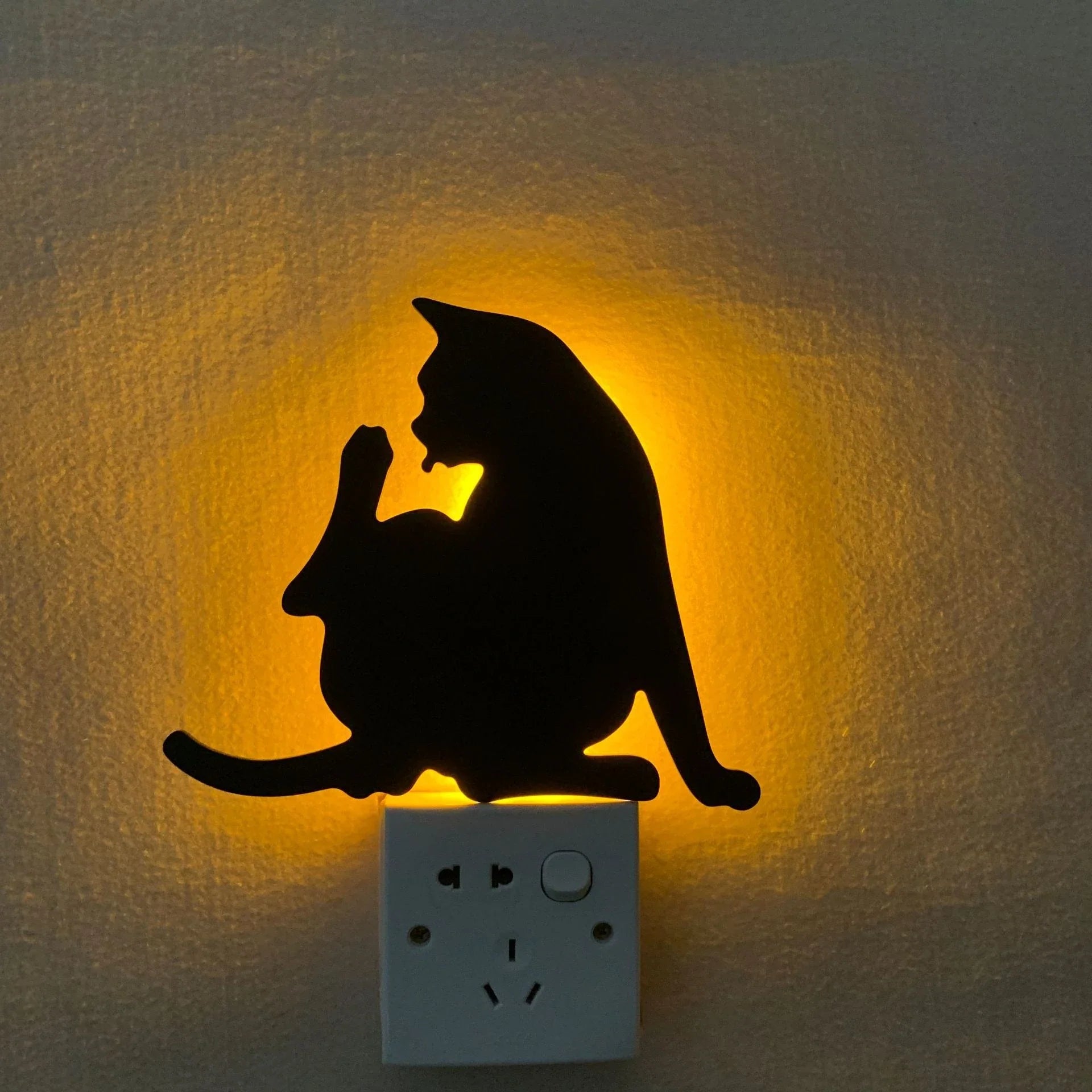 A stylish cat-shaped smart sensor night light that automatically illuminates a room when motion is detected, creating a warm and cozy atmosphere.