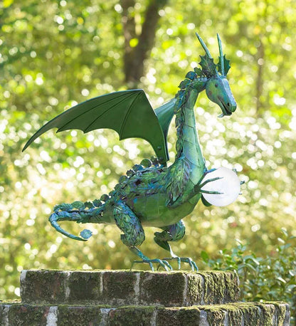 Enchanting green dragon garden statue with serene expression and solar-powered illuminating orb
