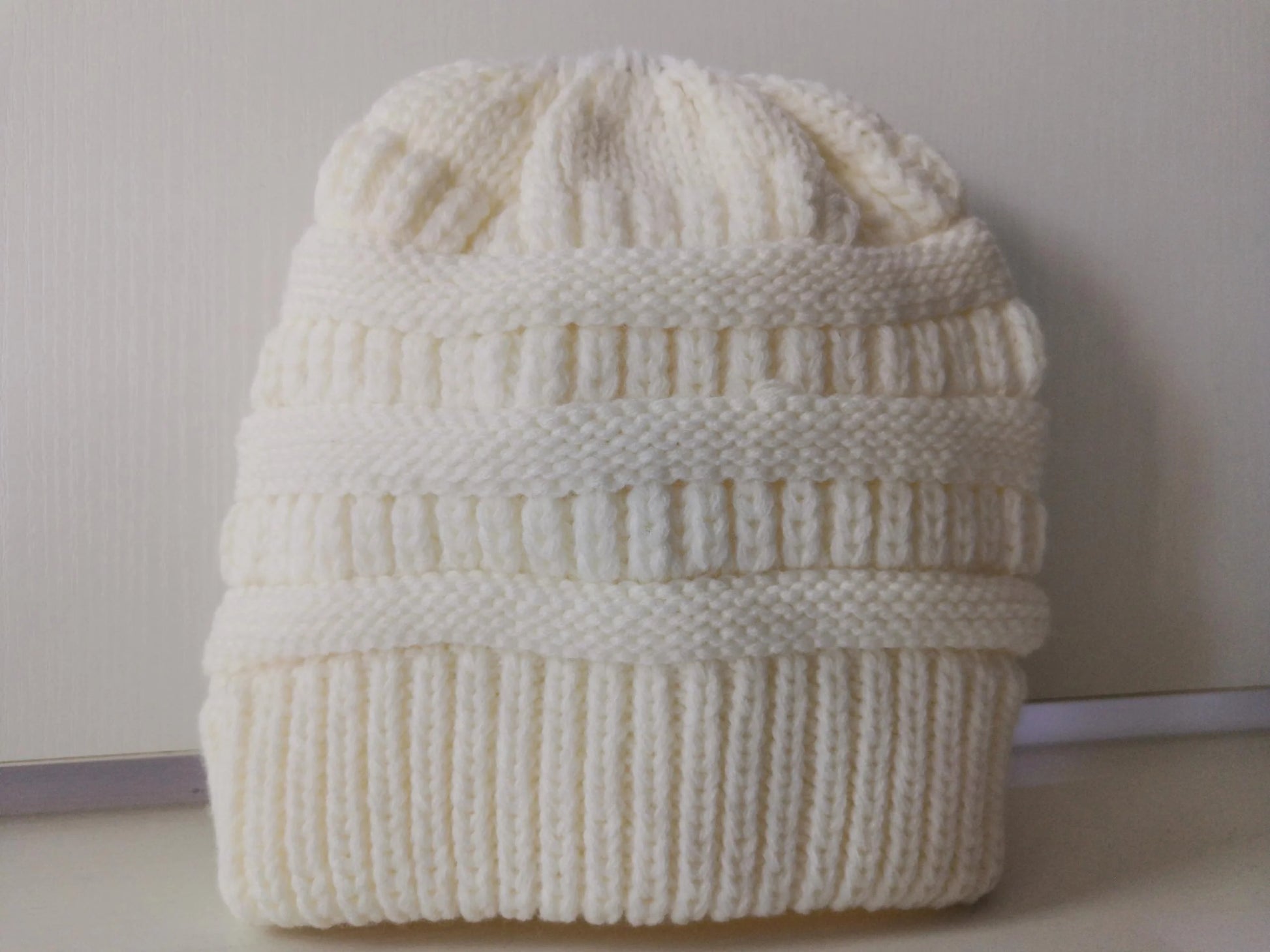 Stylish knitted wool beanie for British ladies with a discreet ponytail hole and a variety of vibrant colour options