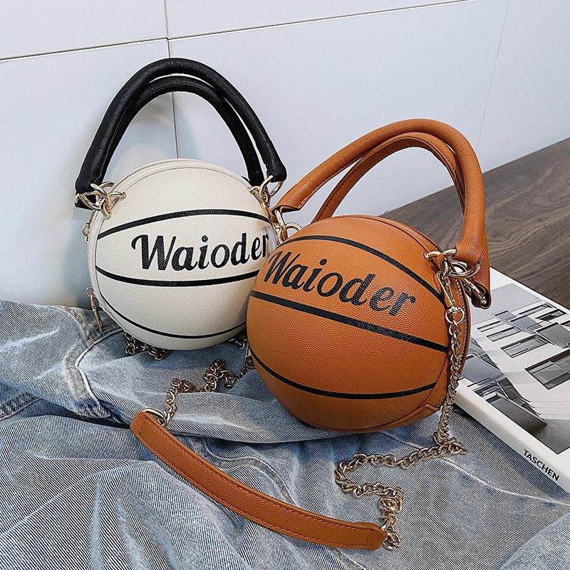 Basketball-shaped handbag in pink, white, black, or brown with adjustable chain shoulder strap