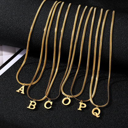 Gold-coloured A-Z letter pendant necklace on a snake chain