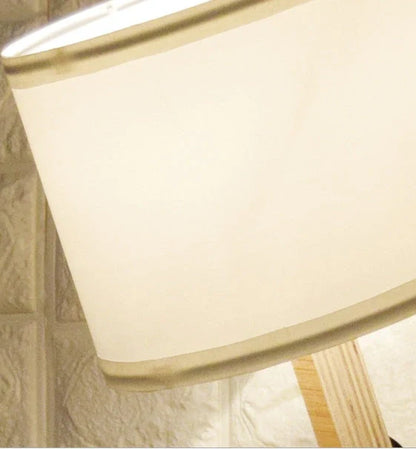 Humanoid table lamp with wooden base and white fabric shade, modern home decor