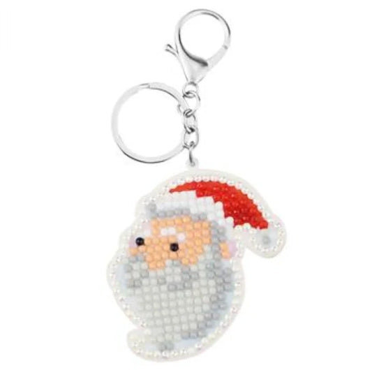 A collection of animal-themed diamond art keychains, including designs such as ladybirds, unicorns, cats, and Santa Claus figures.