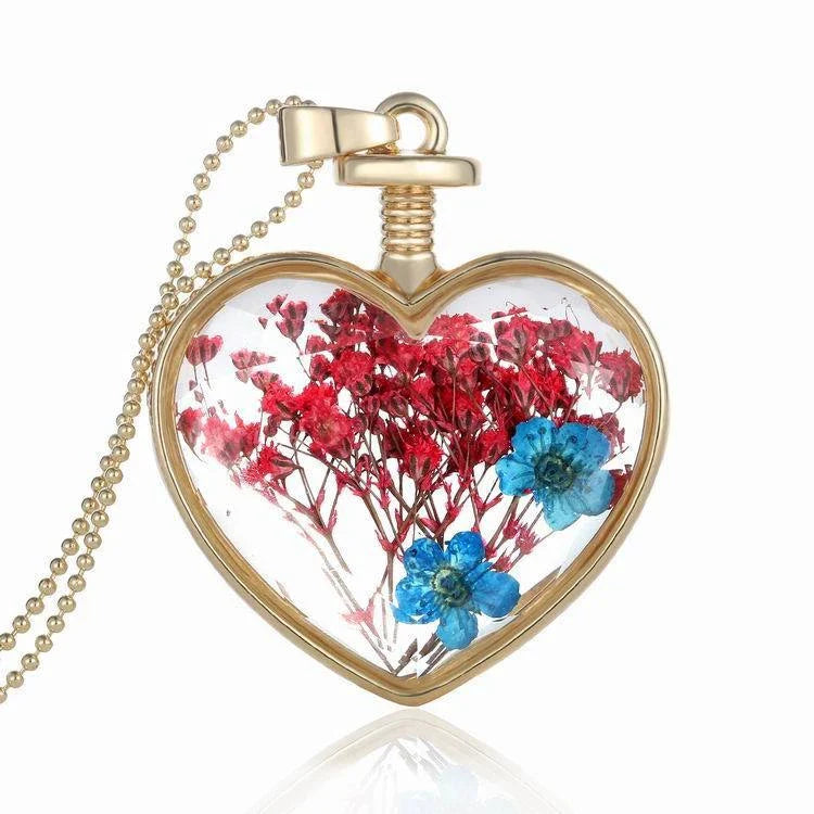 Elegant glass-encased dried flower pendant necklace with bead chain, showcasing a variety of preserved floral arrangements.