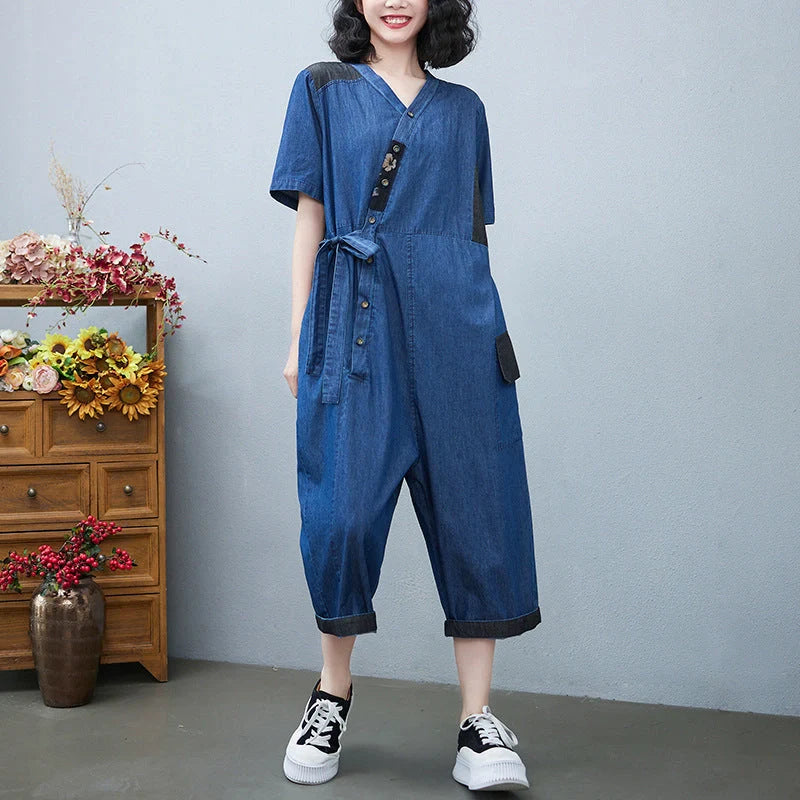 Women's denim drawstring jumpsuit with wide legs and cropped length, available in blue and black colours