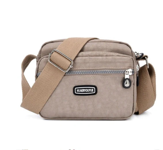 Small square messenger bag in water-repellent nylon with multi-compartment design