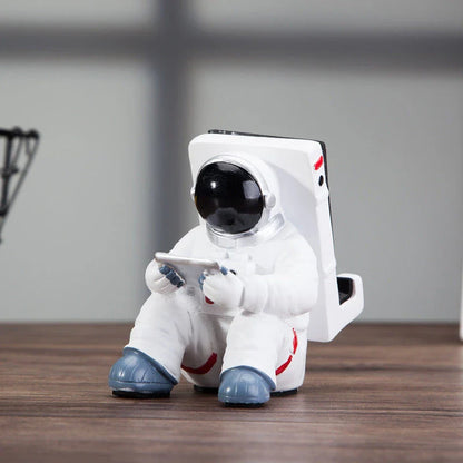 Charming astronaut-themed mobile phone stand made of high-quality resin, designed to securely hold your phone on your desk or workspace