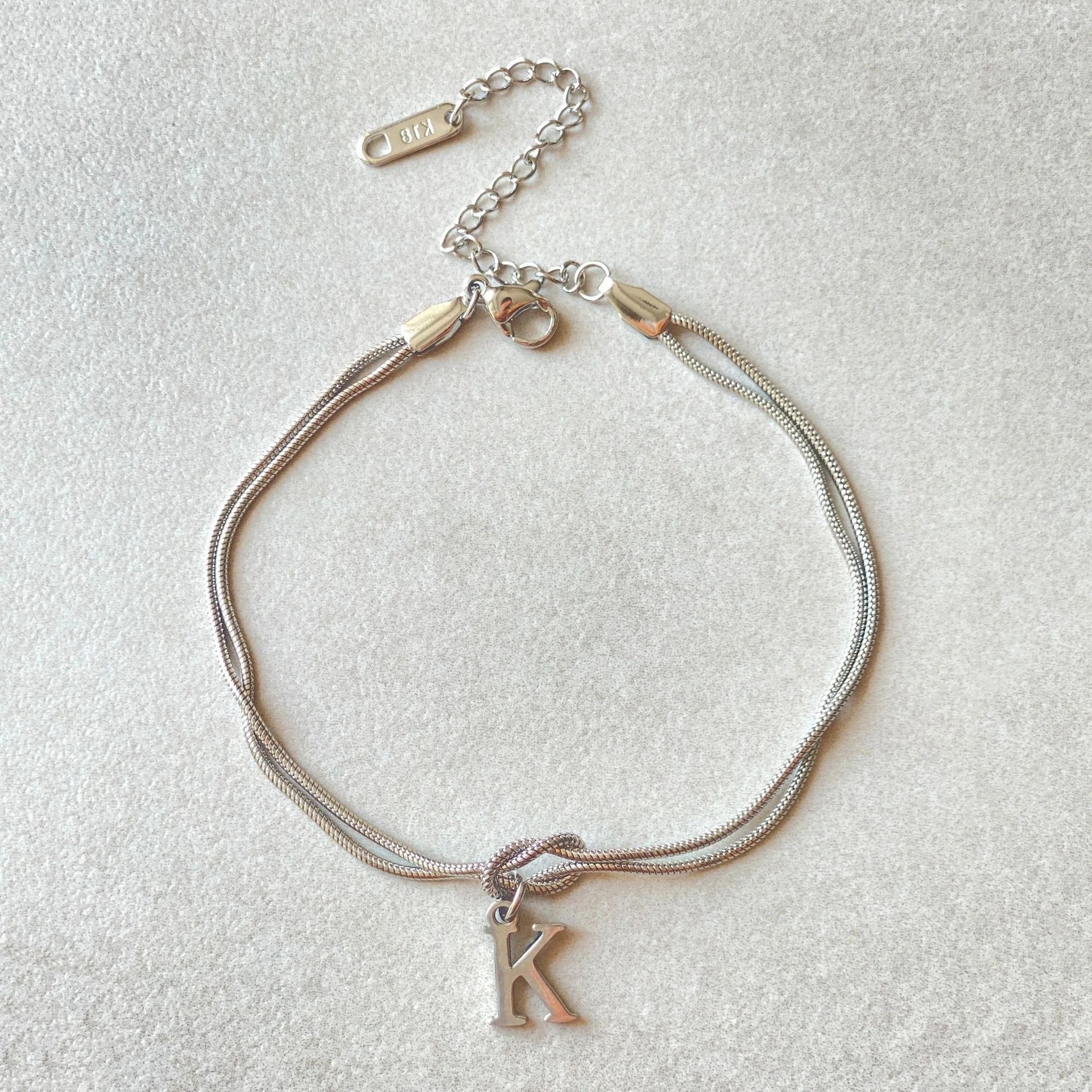 Personalised gold and silver love knot bracelets for couples, perfect as Valentine's Day gifts.