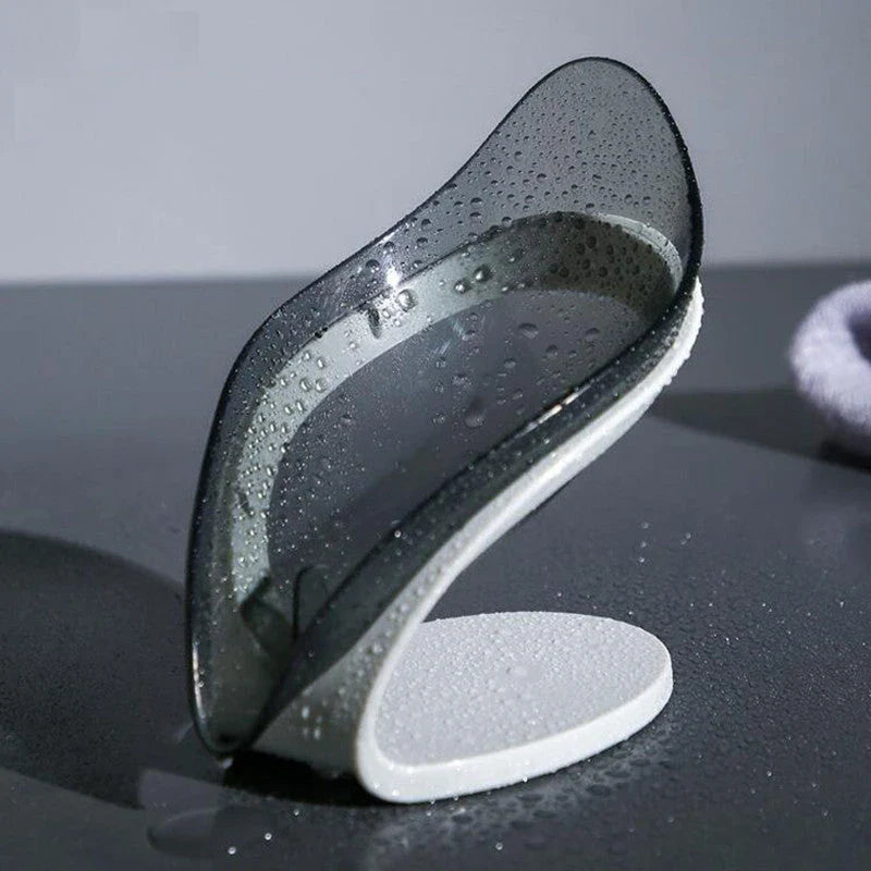Elegant leaf-shaped soap dish with self-draining design and stable triangular shape, made of durable ABS material