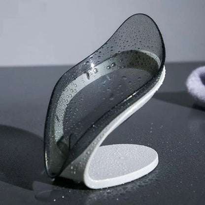 Elegant leaf-shaped soap dish with self-draining design and stable triangular shape, made of durable ABS material