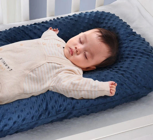 Newborn bionic nap bed in blue and yellow, designed for safety and comfort