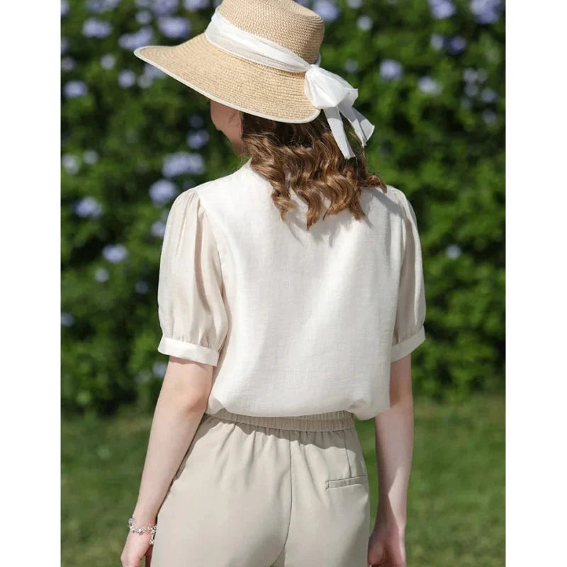 Elegant silk blend blouse with Chinese-inspired puff sleeves and a timeless design