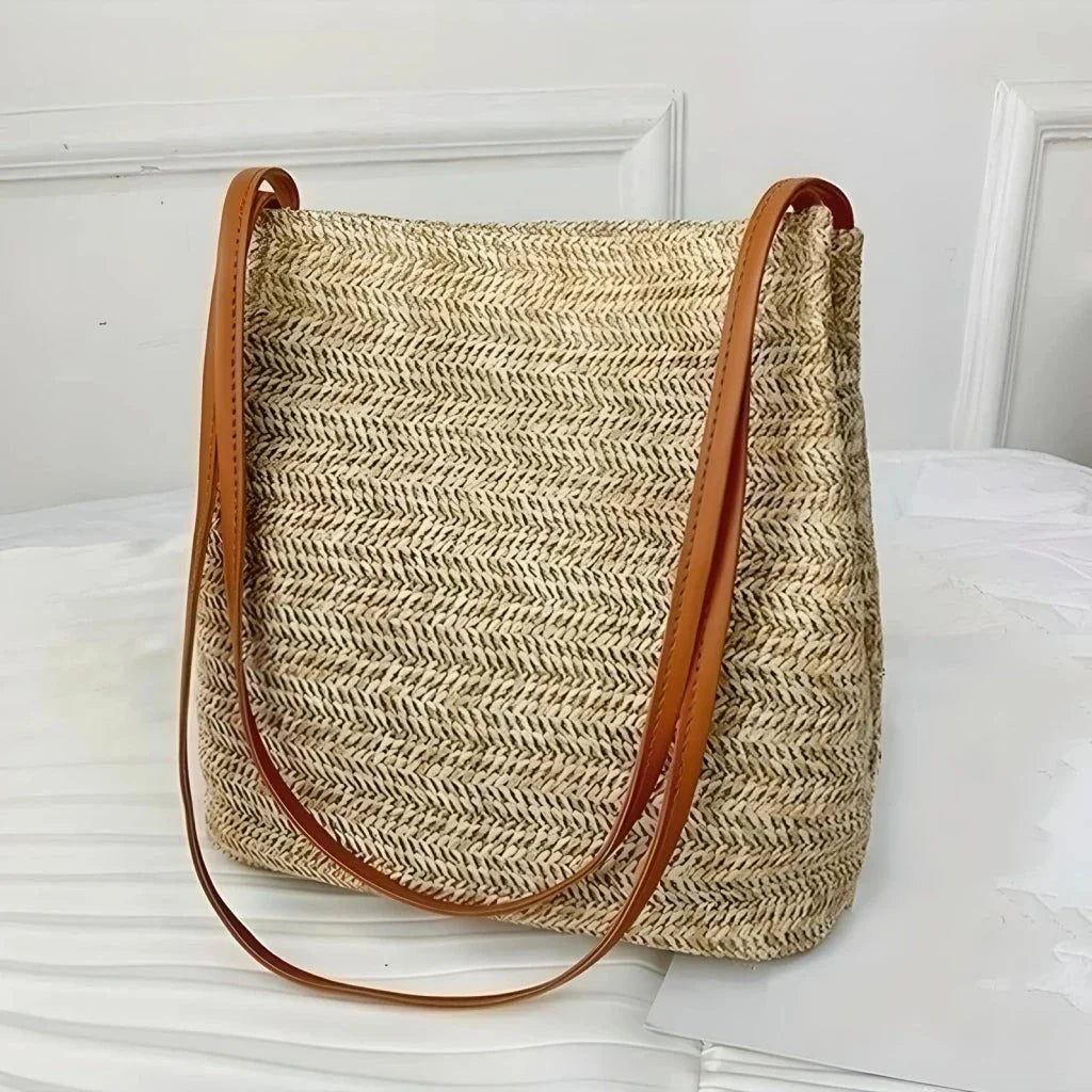 Bohemian straw woven shoulder bag with a compact yet spacious design, perfect for summer outings and beach getaways.