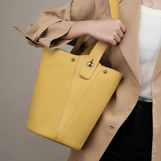 Luxurious genuine leather bucket shoulder bag with adjustable strap and interior pockets, perfect for British women's everyday use