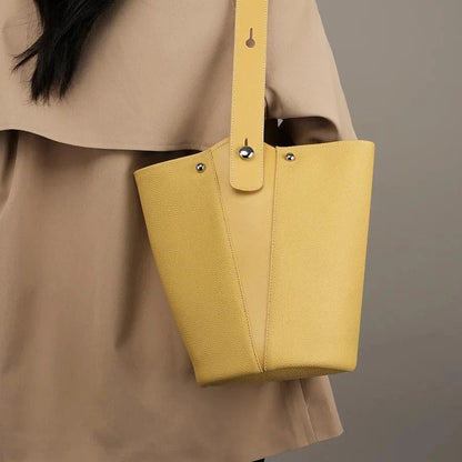 Luxurious genuine leather bucket shoulder bag with adjustable strap and interior pockets, perfect for British women's everyday use