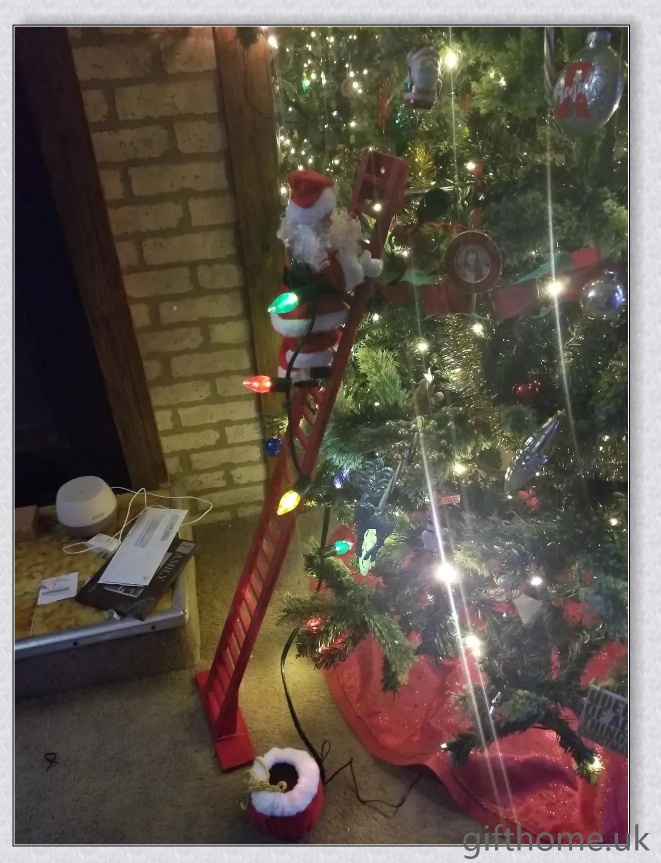 Climbing Santa - A festive Christmas decoration with a Santa Claus figure climbing up and down a ladder while playing Jingle Bells
