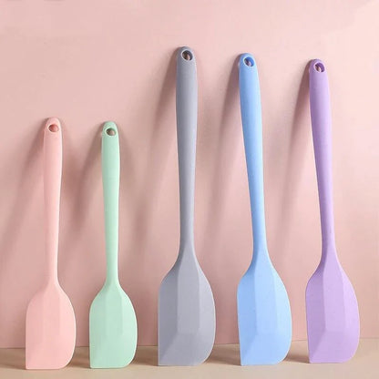 A vibrant red silicone baking spatula with an ergonomic handle and double-sided arc design, perfect for a variety of cooking and baking tasks.
