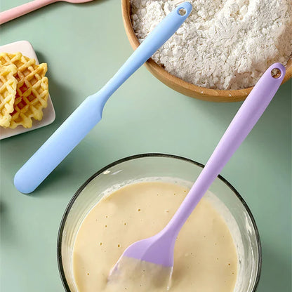 A vibrant red silicone baking spatula with an ergonomic handle and double-sided arc design, perfect for a variety of cooking and baking tasks.