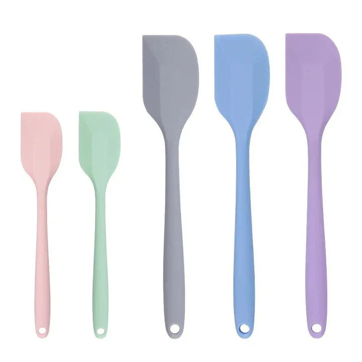 A vibrant red silicone baking spatula with an ergonomic handle and double-sided arc design, perfect for a variety of cooking and baking tasks.