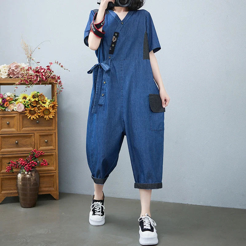 Women's denim drawstring jumpsuit with wide legs and cropped length, available in blue and black colours