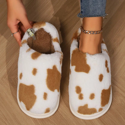 Cozy cow print plush slippers with a non-slip sole, perfect for indoor comfort and warmth