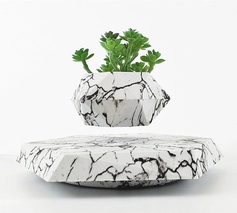 Levitating marble bonsai pot floating above magnetic base